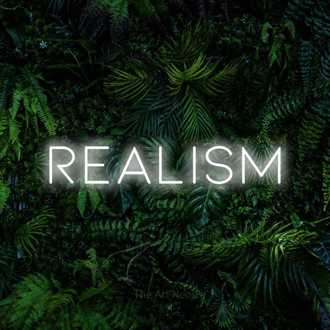 LED neon sign reading “REALISM”, arranged in a single line.