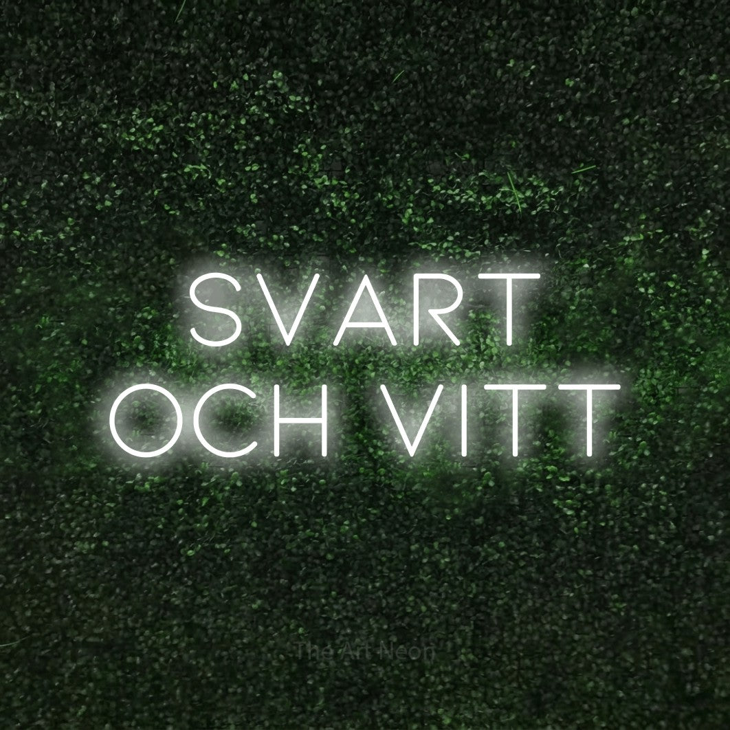 LED neon sign reading “svart och vitt”, arranged in 2 lines.