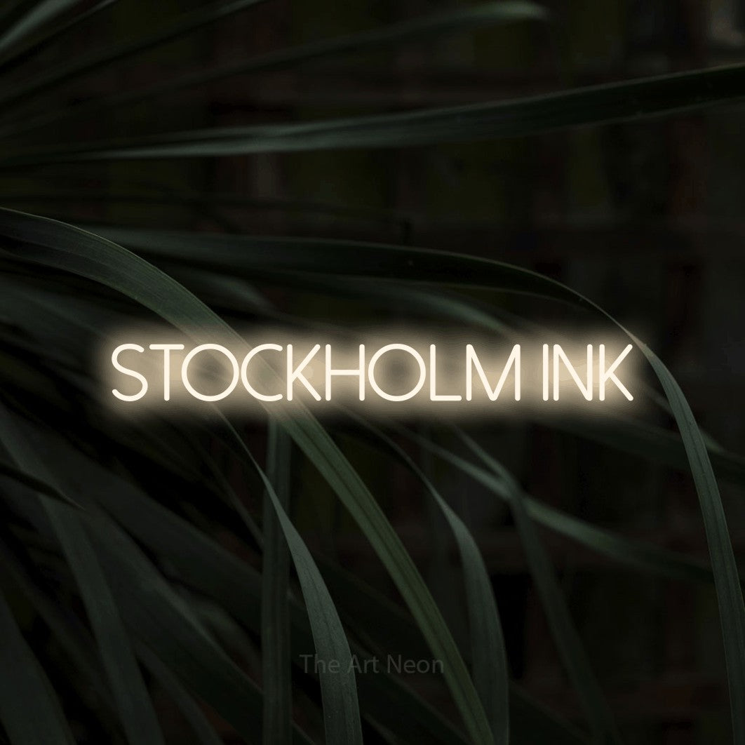 LED neon sign reading “Stockholm Ink”, arranged in a single line.