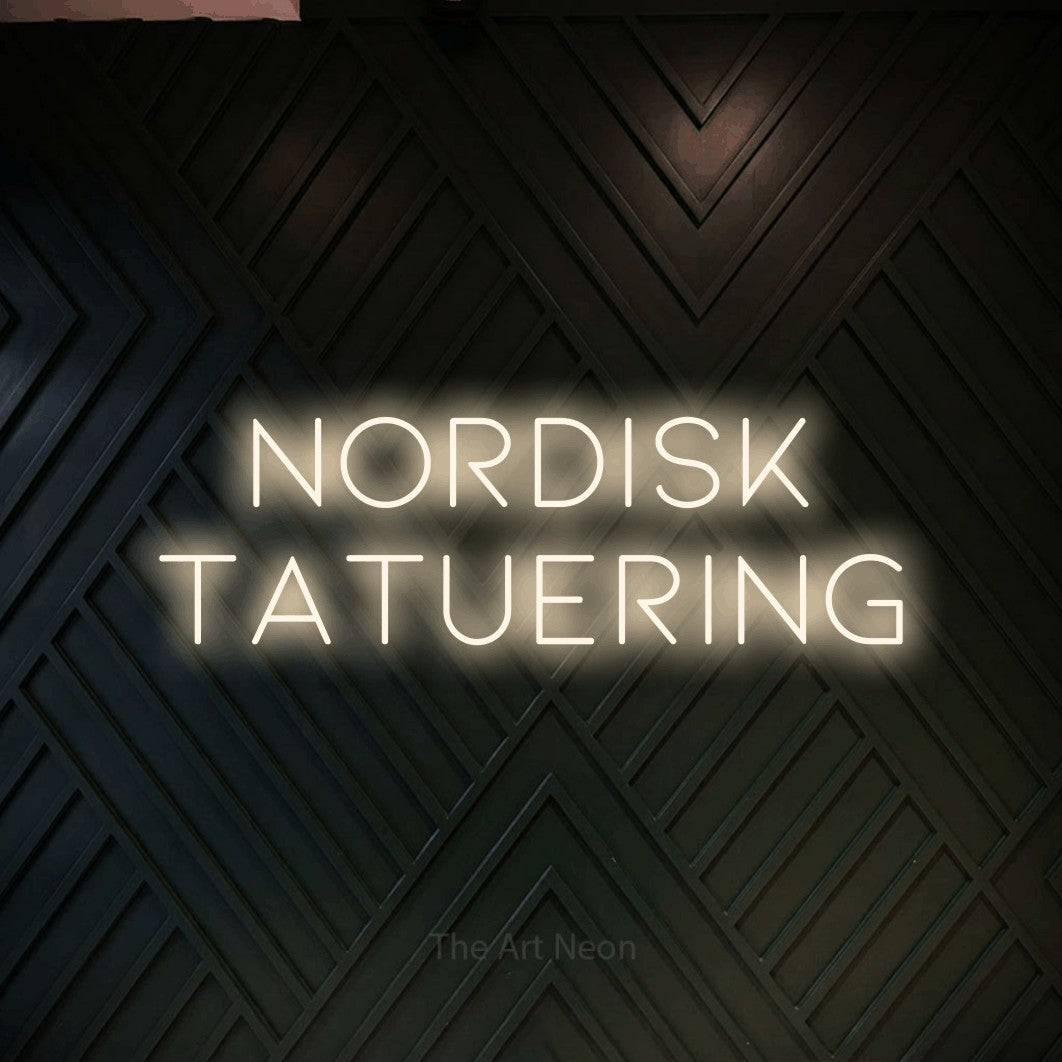 LED neon sign reading “nordisk tatuering”, arranged in 2 lines.