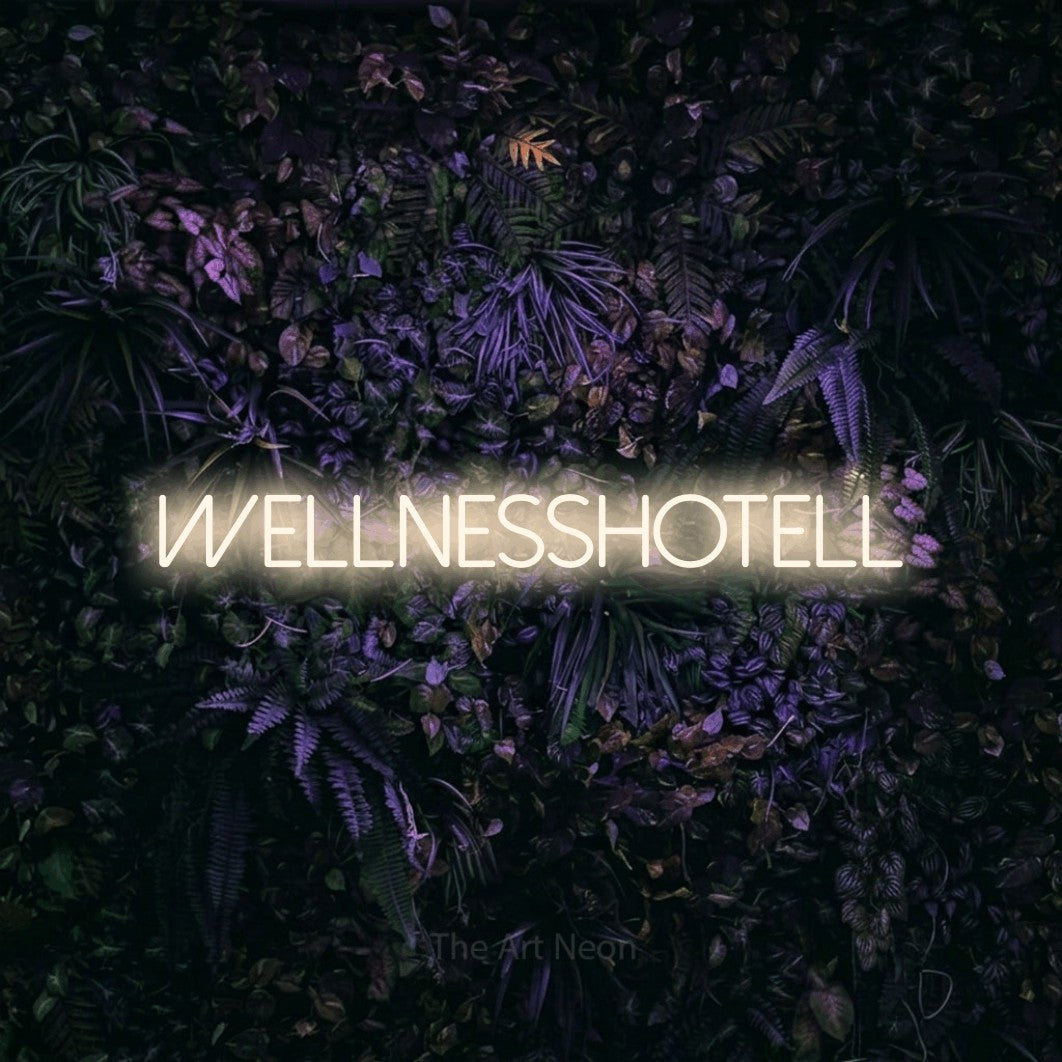 LED neon sign reading “Wellnesshotell”, arranged in a single line.