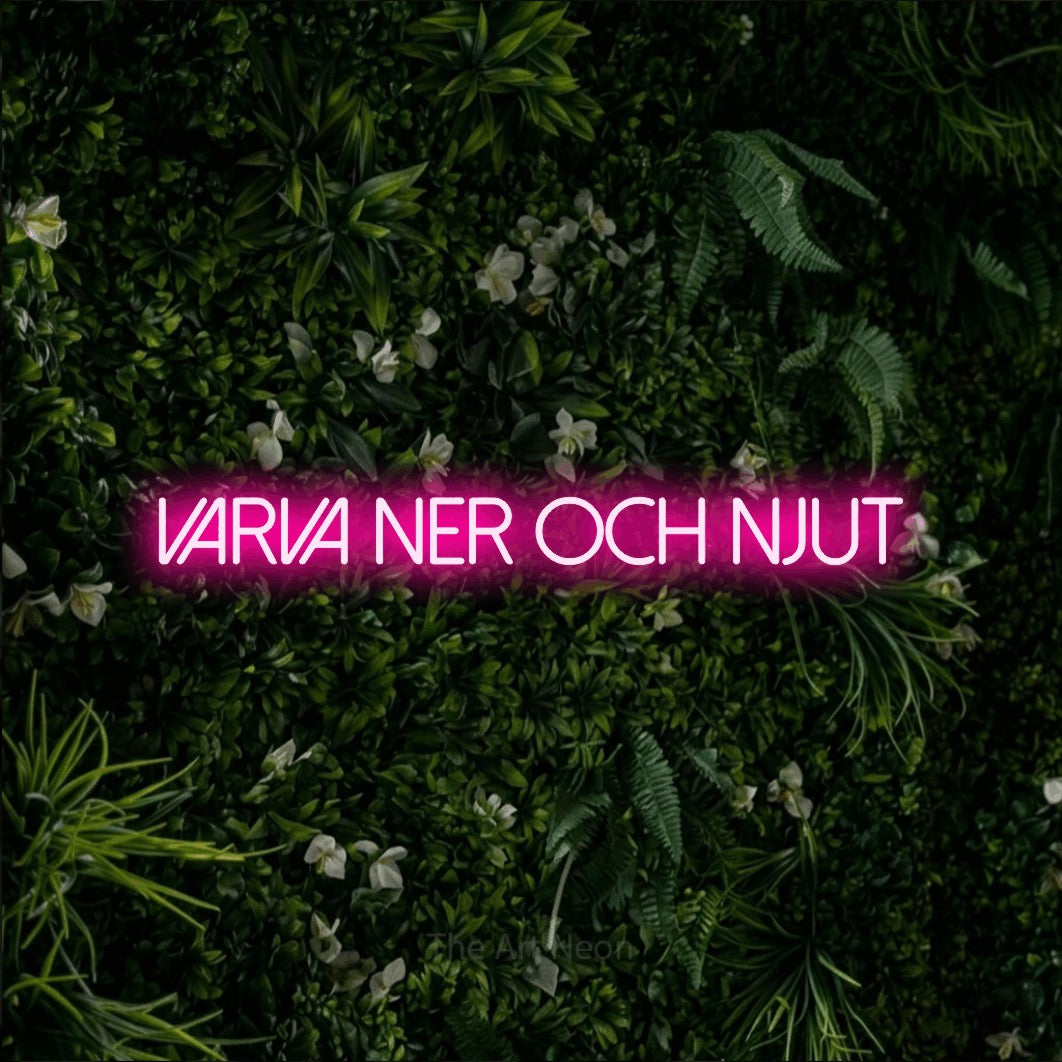 LED neon sign reading “varva ner och njut”, arranged in a single line.