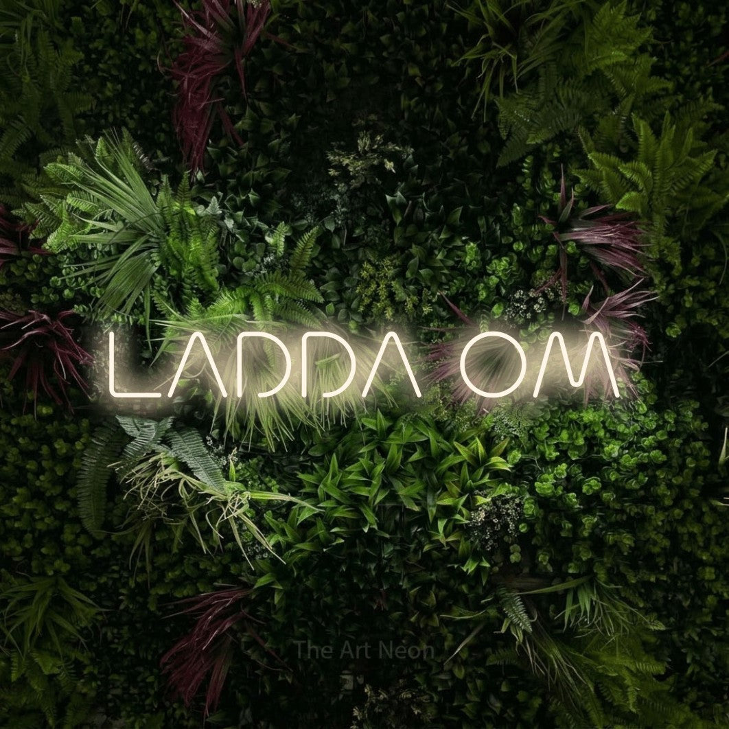 LED neon sign reading “LADDA OM”, arranged in a single line.