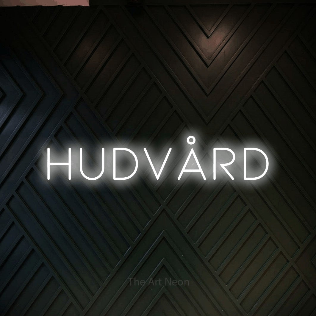 LED neon sign reading “hudvård”, arranged in a single line.