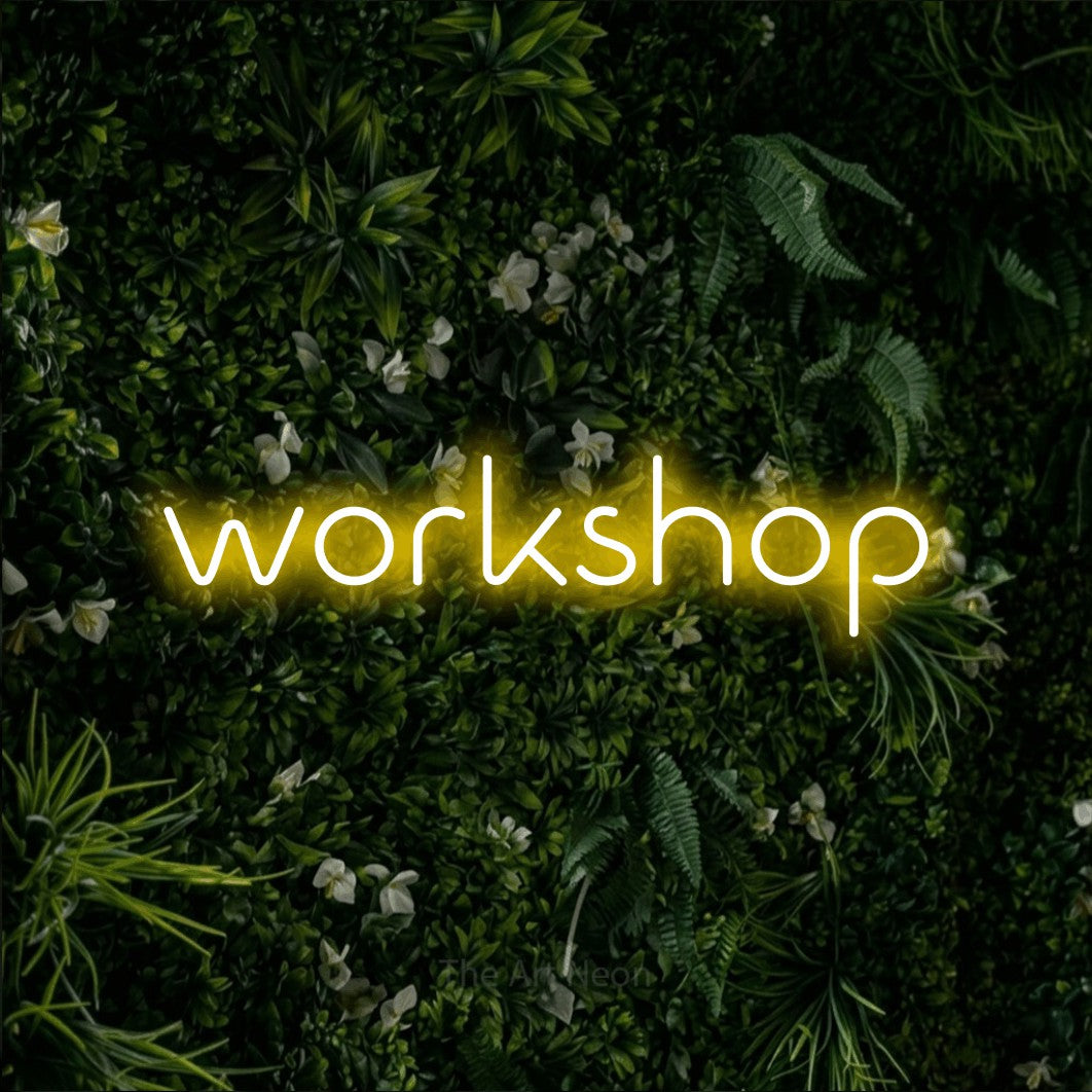 LED neon sign reading “workshop”, arranged in a single line.