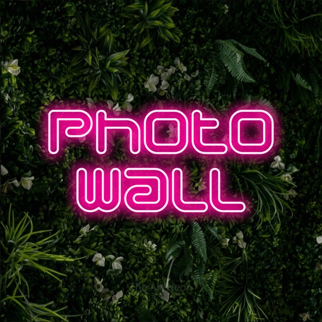 LED neon sign reading “photo wall”, arranged in 2 lines.