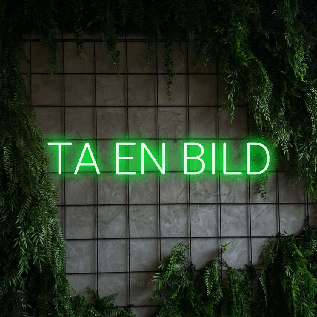 LED neon sign reading “TA EN BILD”, arranged in a single line.