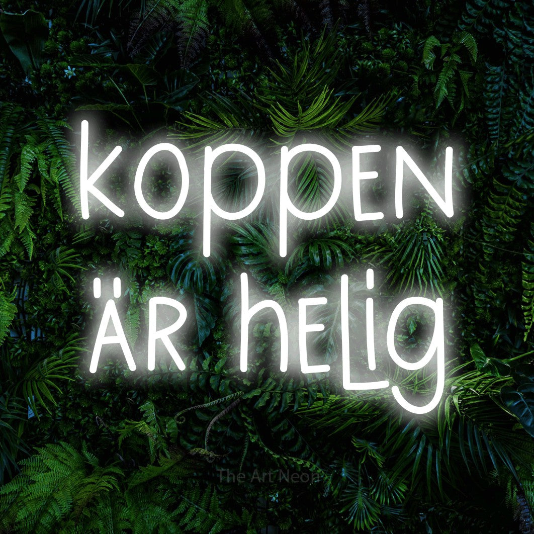LED neon sign reading “koppen är helig”, arranged in 2 lines.