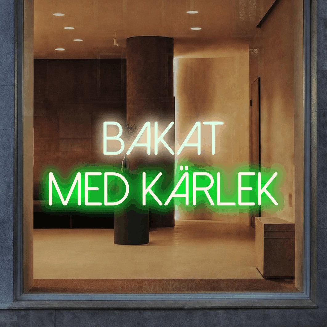 LED neon sign reading “BAKAT MED KÄRLEK”, arranged in 2 lines.