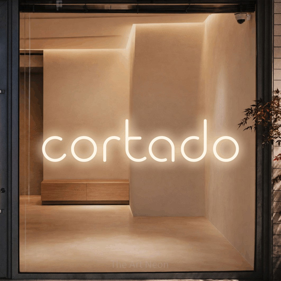 LED neon sign reading “cortado”, arranged in a single line.