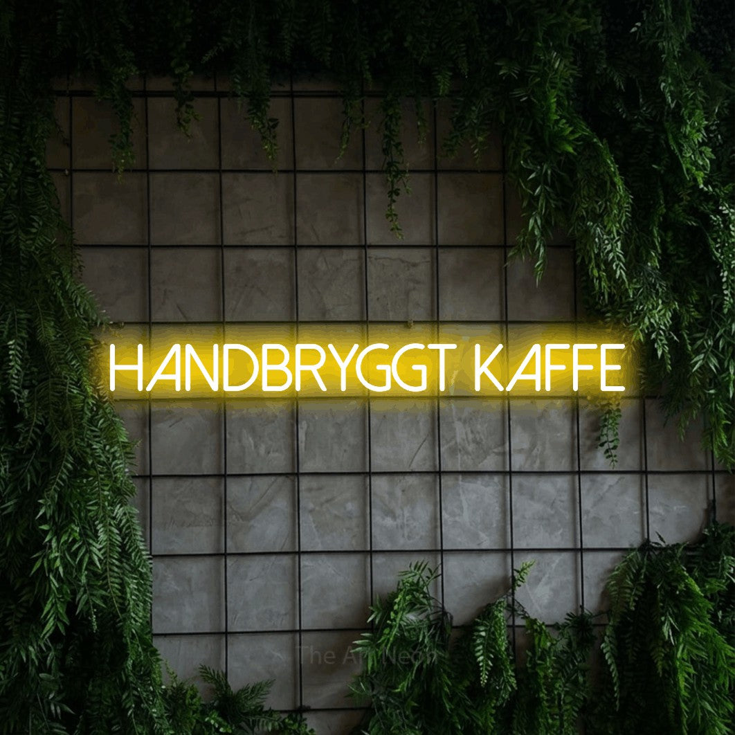 LED neon sign reading “Handbryggt Kaffe”, arranged in a single line.