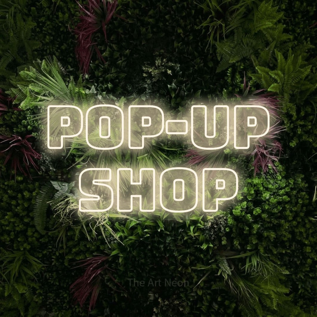 LED neon sign reading “Pop-Up Shop”, arranged in 2 lines.