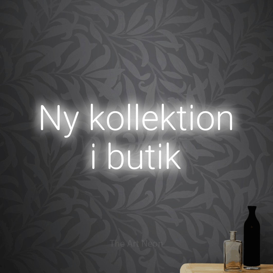 LED neon sign reading “Ny kollektion i butik”, arranged in 2 lines.