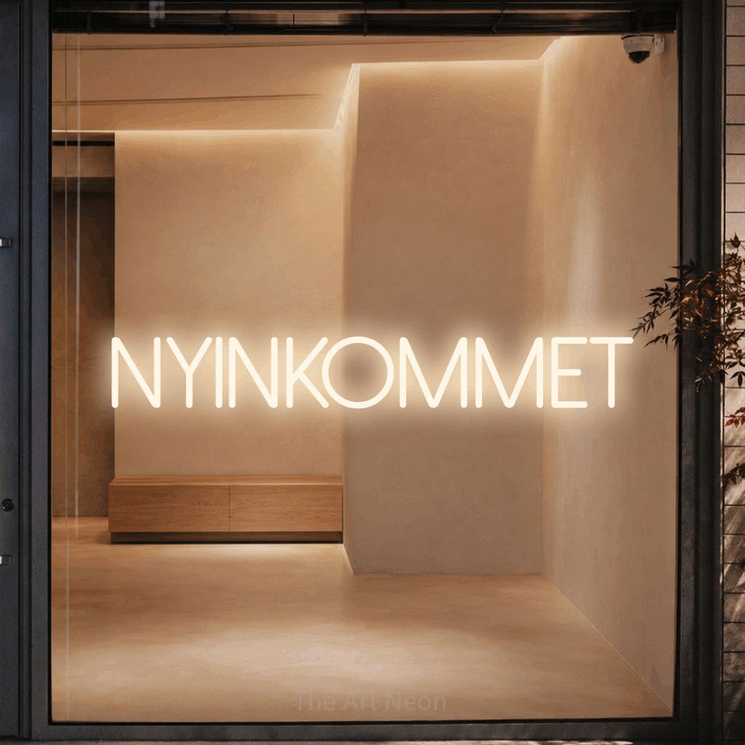 LED neon sign reading “nyinkommet”, arranged in a single line.