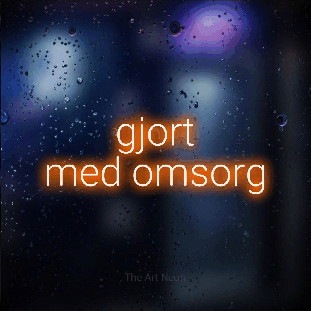 LED neon sign reading “gjort med omsorg”, arranged in 2 lines.