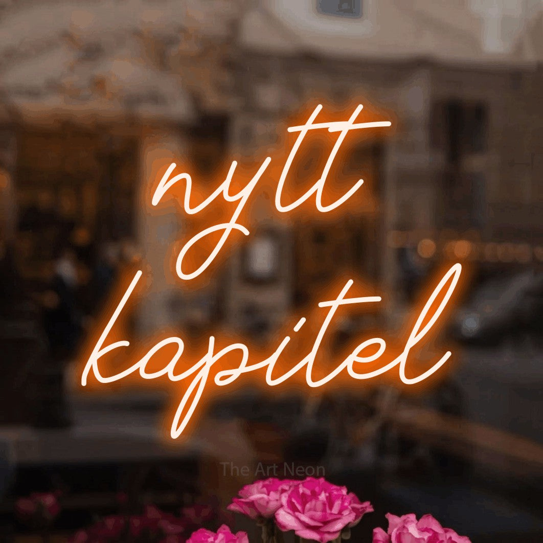 LED neon sign reading “nytt kapitel”, arranged in 2 lines.