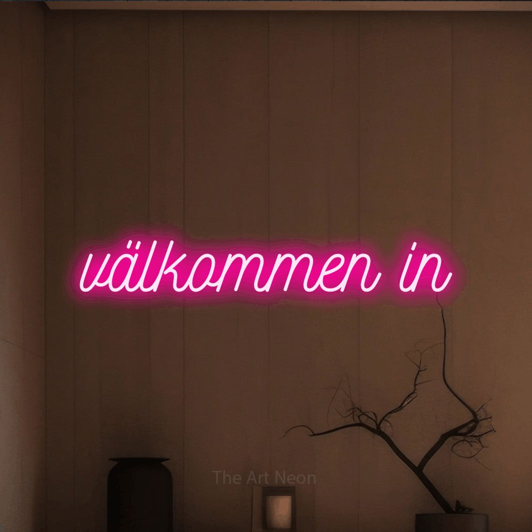 LED neon sign reading “välkommen in”, arranged in a single line.
