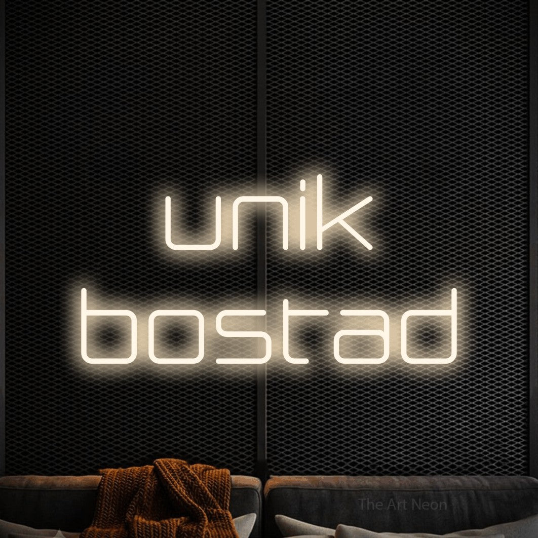 LED neon sign reading “unik bostad”, arranged in 2 lines.