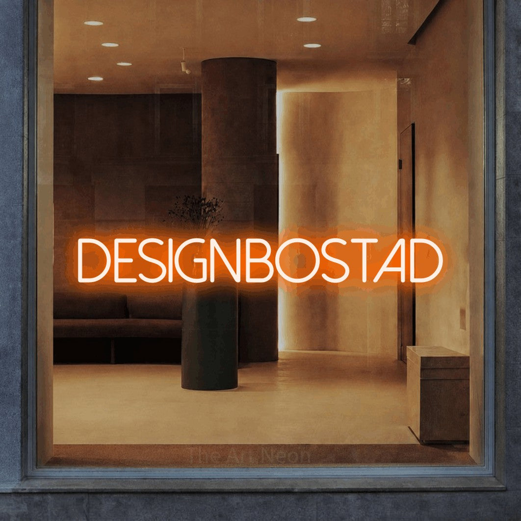 LED neon sign reading “Designbostad”, arranged in a single line.