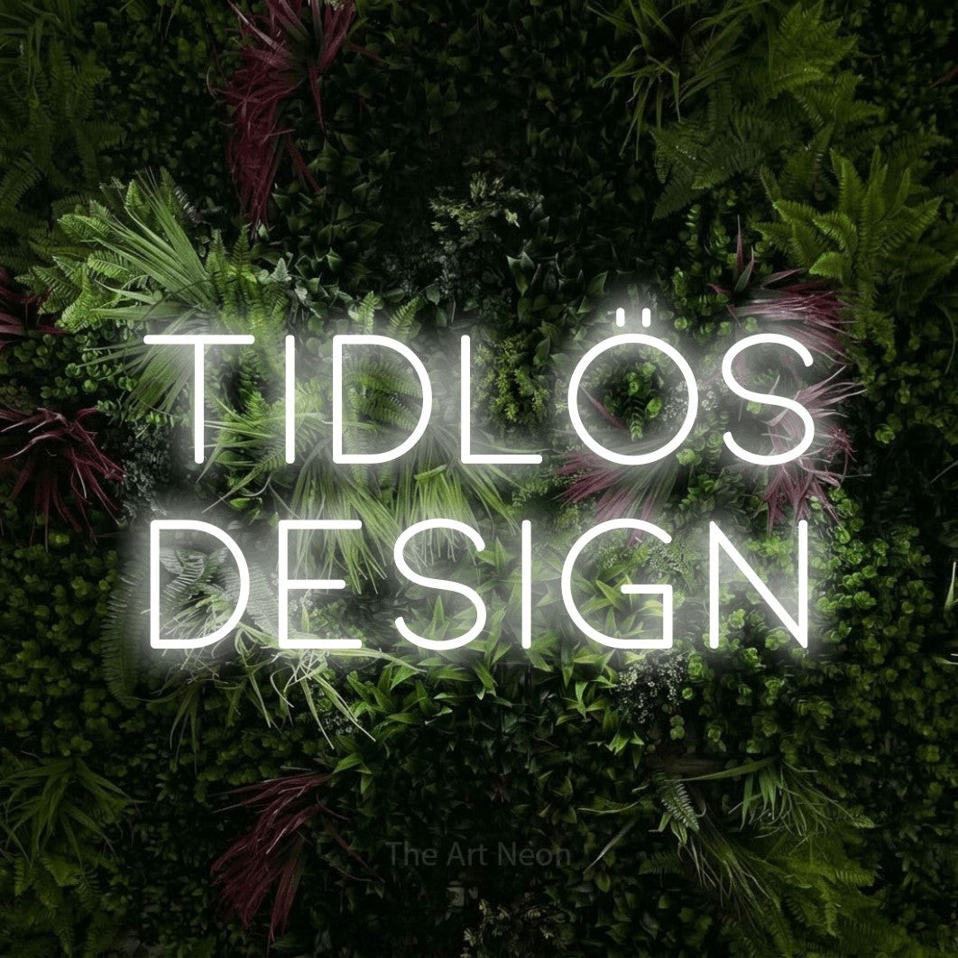 LED neon sign reading “TIDLÖS DESIGN”, arranged in 2 lines.
