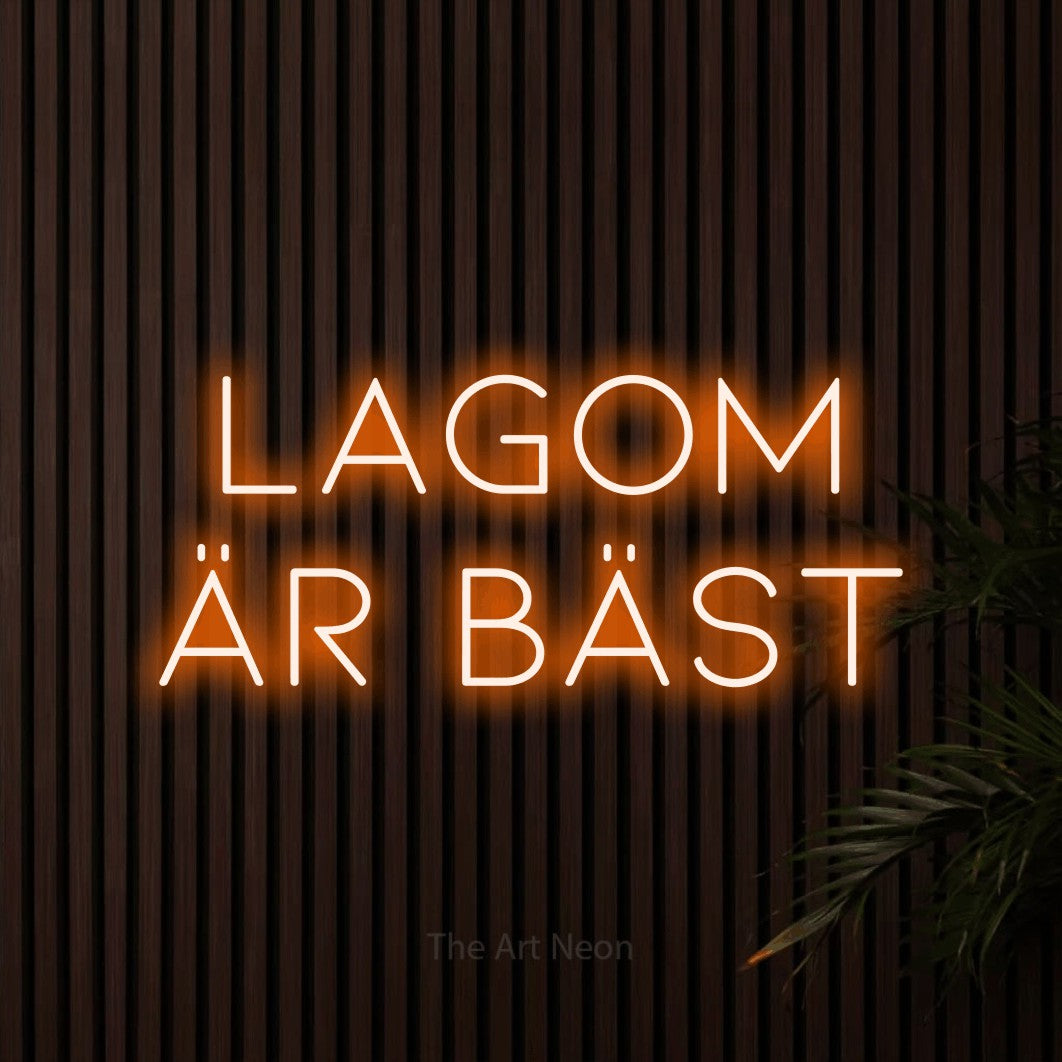 LED neon sign reading “LAGOM ÄR BÄST”, arranged in 2 lines.