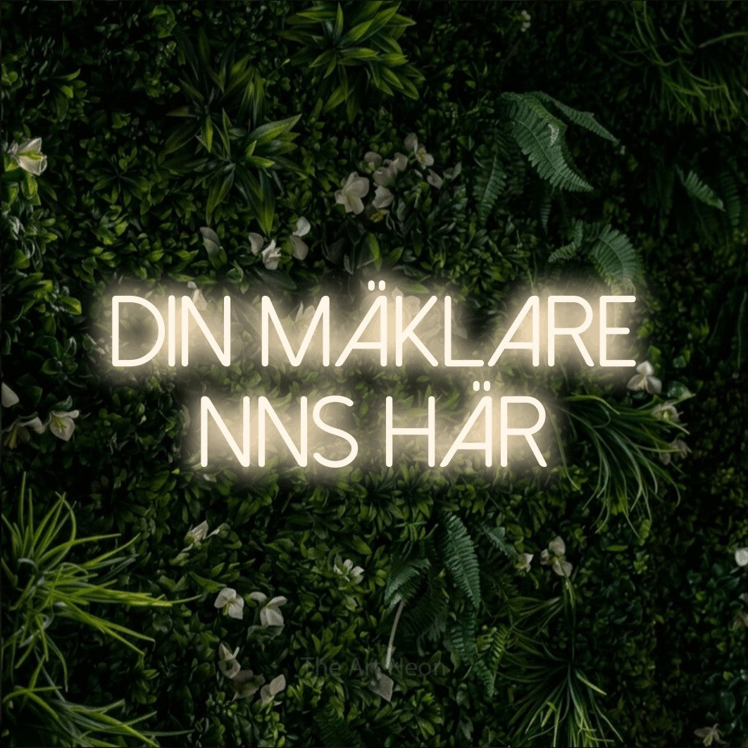 LED neon sign reading “din mäklare finns här”, arranged in 2 lines.