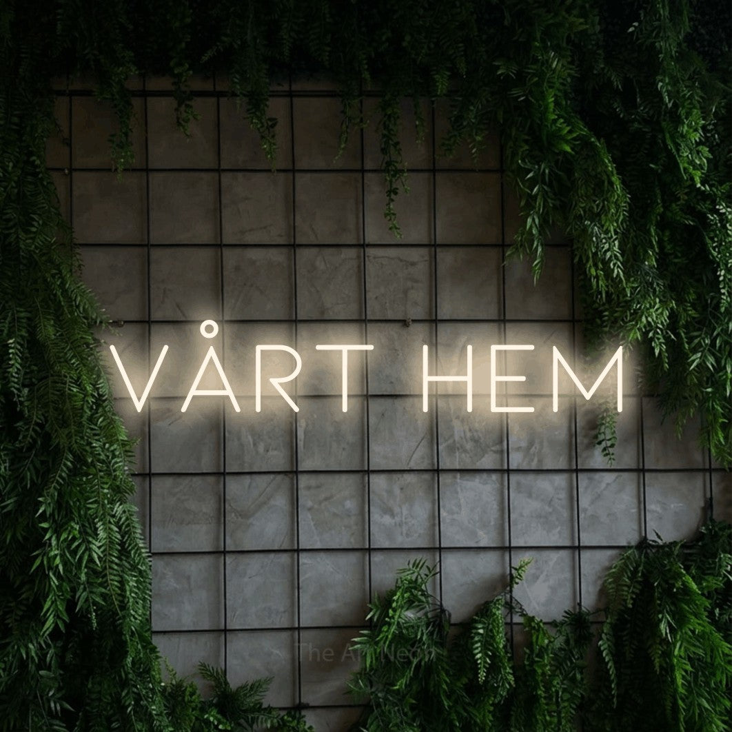 LED neon sign reading “VÅRT HEM”, arranged in a single line.