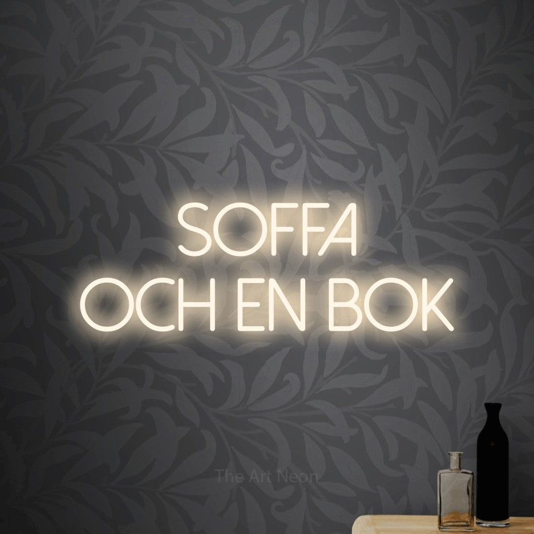 LED neon sign reading “Soffa Och En Bok”, arranged in 2 lines.