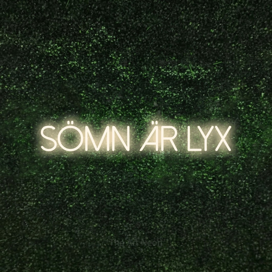 LED neon sign reading “SÖMN ÄR LYX”, arranged in a single line.