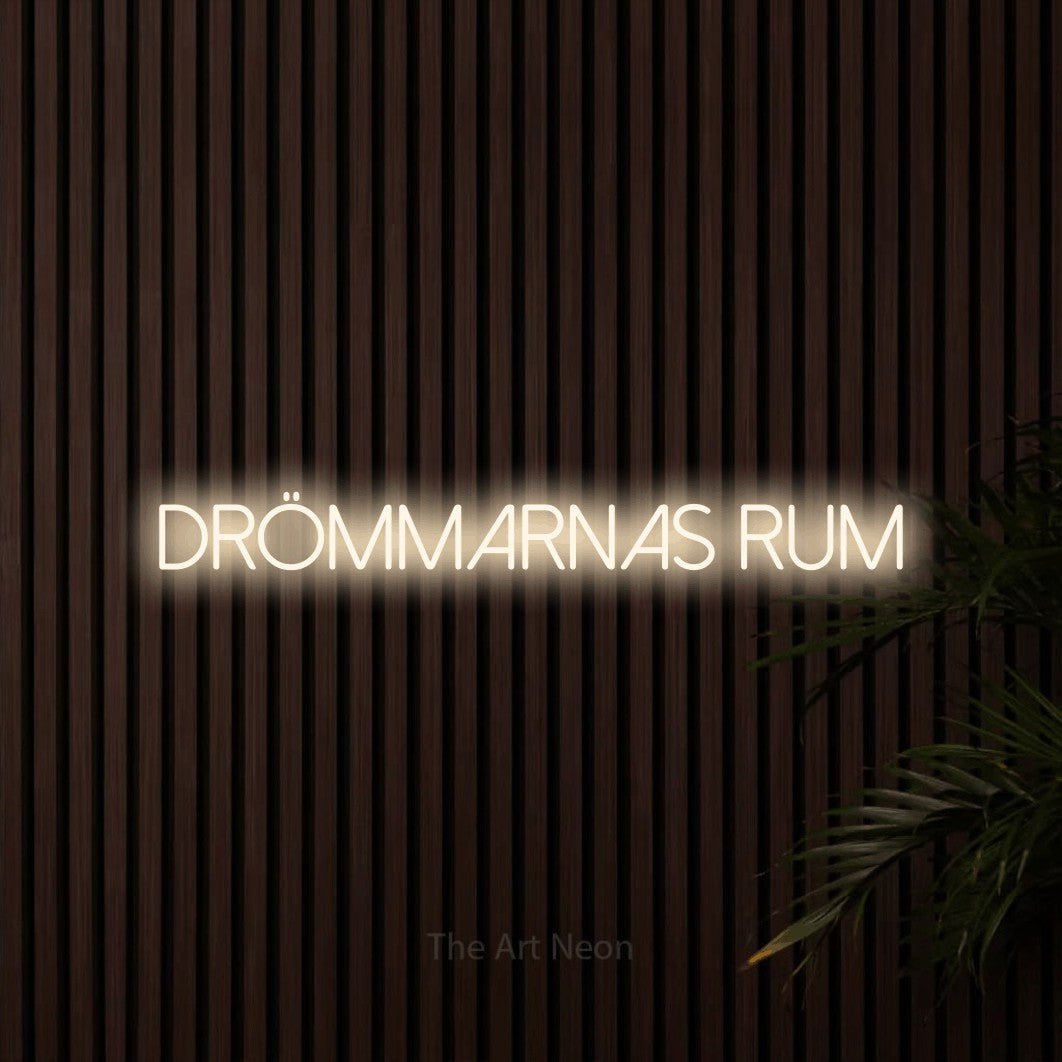 LED neon sign reading “drömmarnas rum”, arranged in a single line.