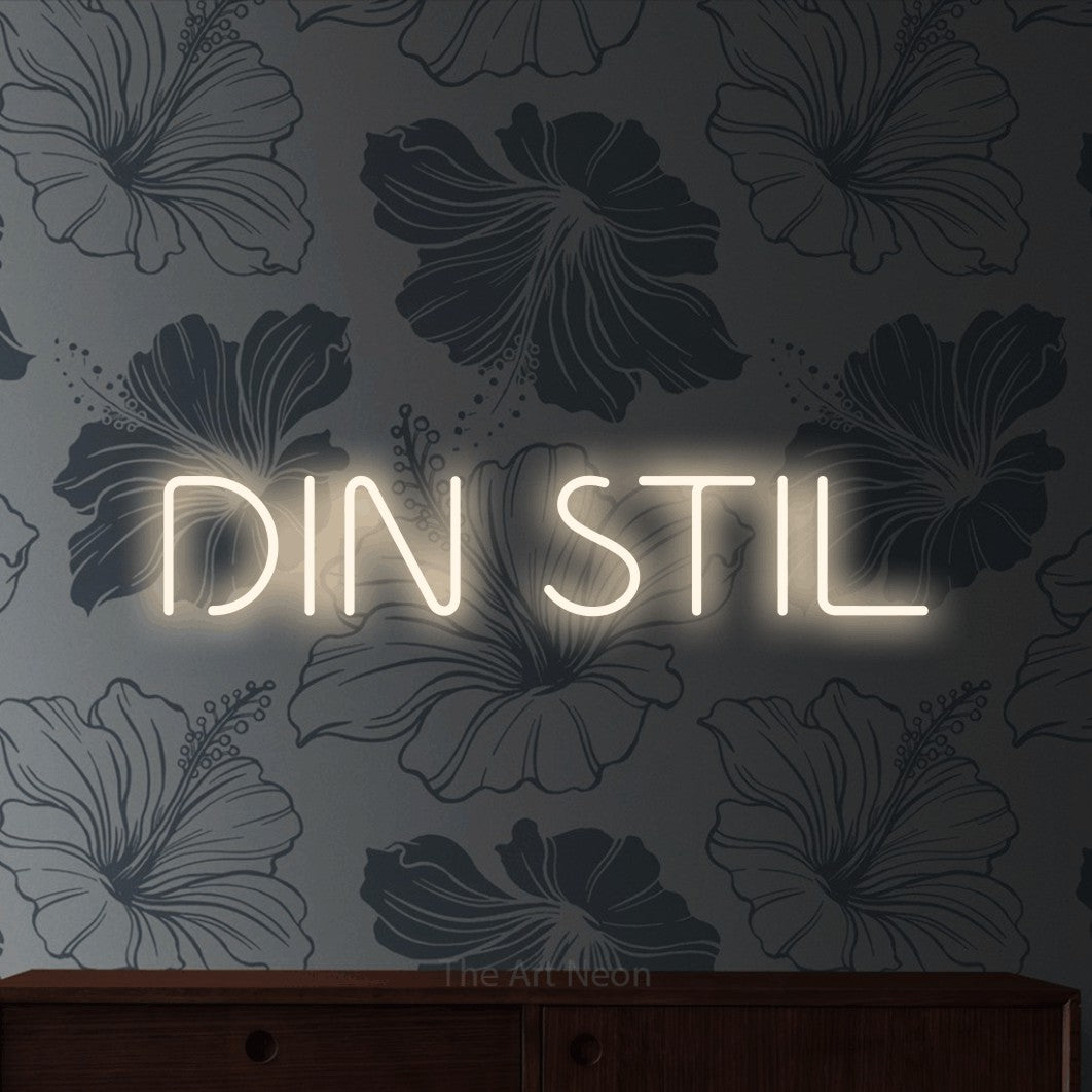 LED neon sign reading “DIN STIL”, arranged in a single line.