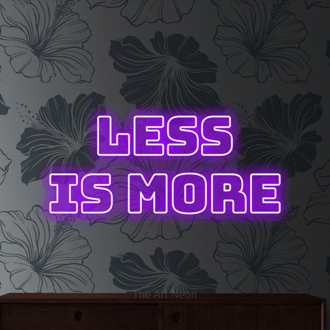 LED neon sign reading “LESS IS MORE”, arranged in 2 lines.
