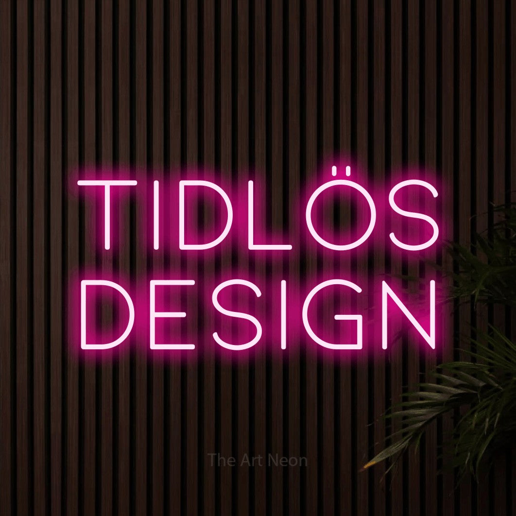 LED neon sign reading “TIDLÖS DESIGN”, arranged in 2 lines.