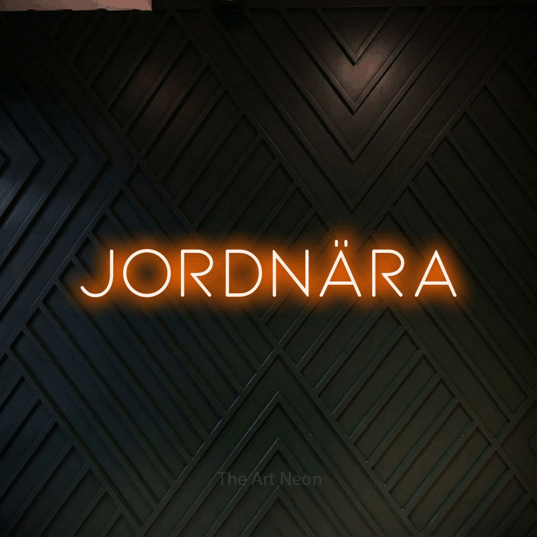LED neon sign reading “JORDNÄRA”, arranged in a single line.