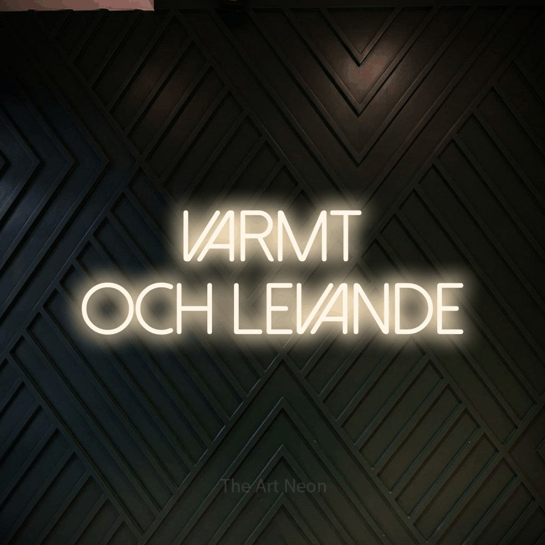 LED neon sign reading “Varmt Och Levande”, arranged in 2 lines.