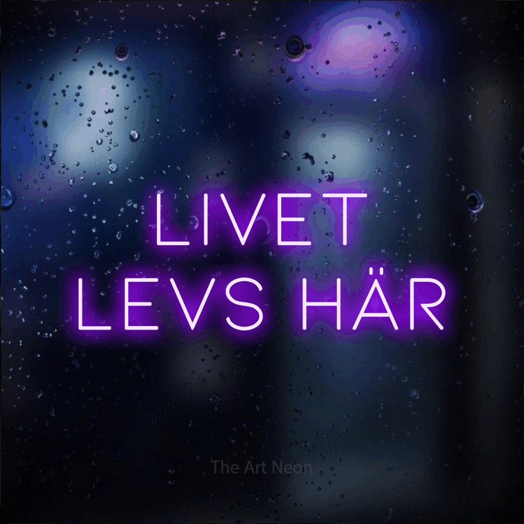LED neon sign reading “Livet Levs Här”, arranged in 2 lines.