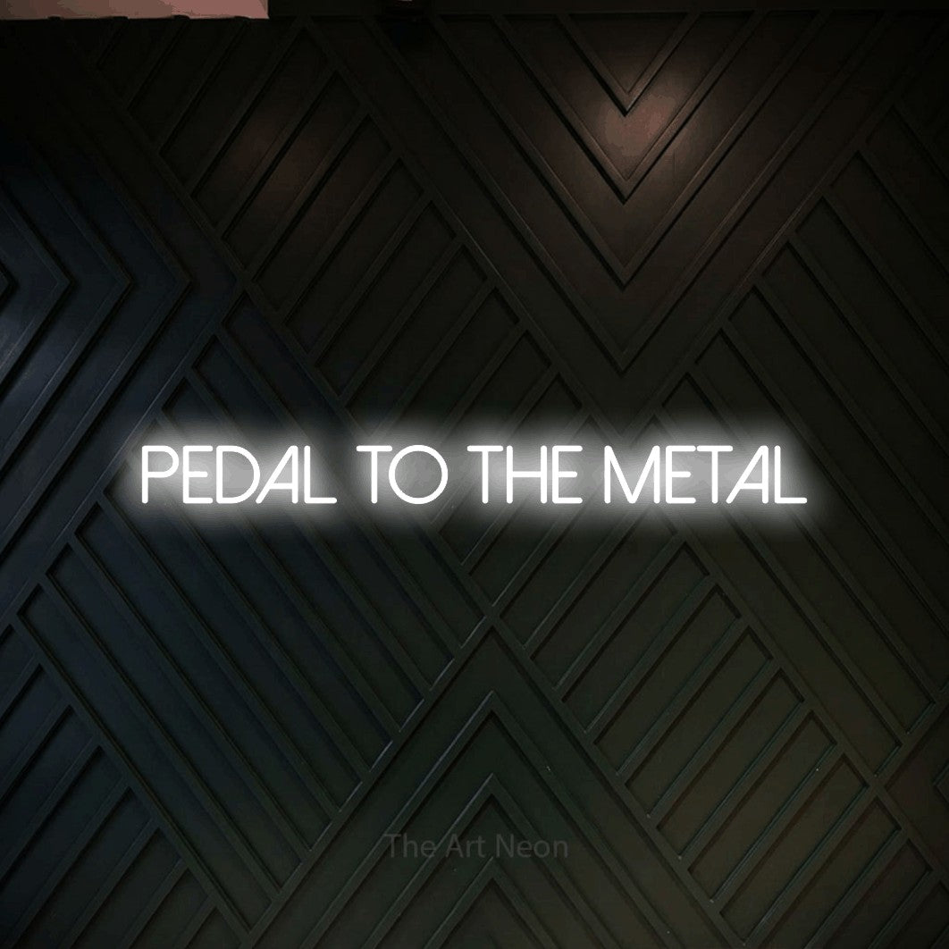 LED neon sign reading “PEDAL to the metal”, arranged in a single line.