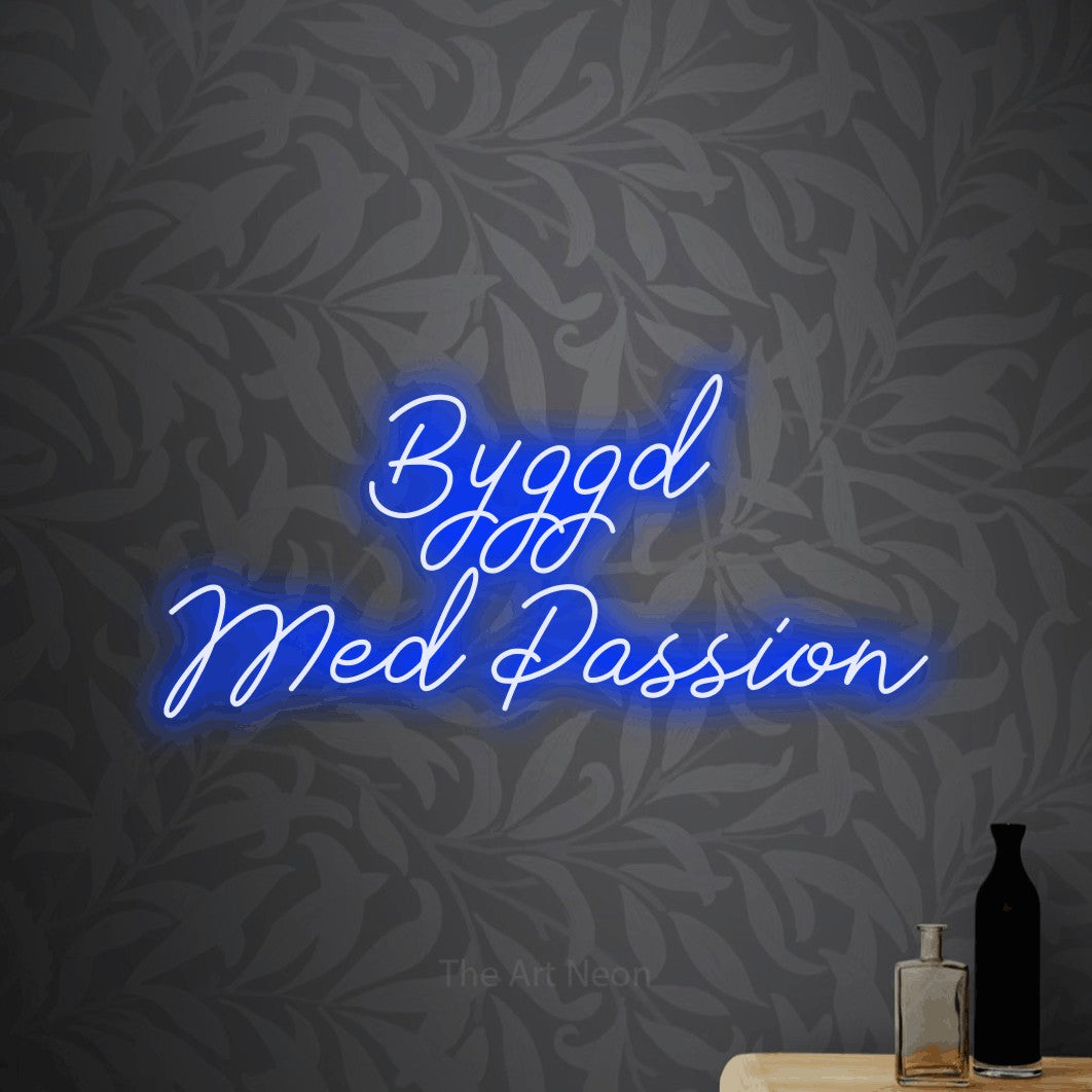LED neon sign reading “Byggd Med Passion”, arranged in 2 lines.