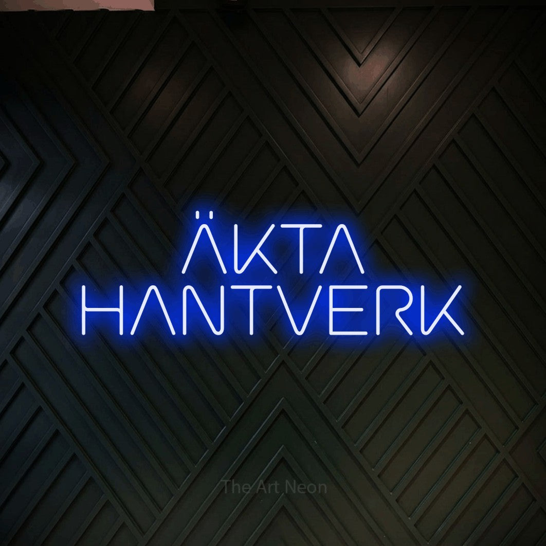 LED neon sign reading “ÄKTA HANTVERK”, arranged in 2 lines.