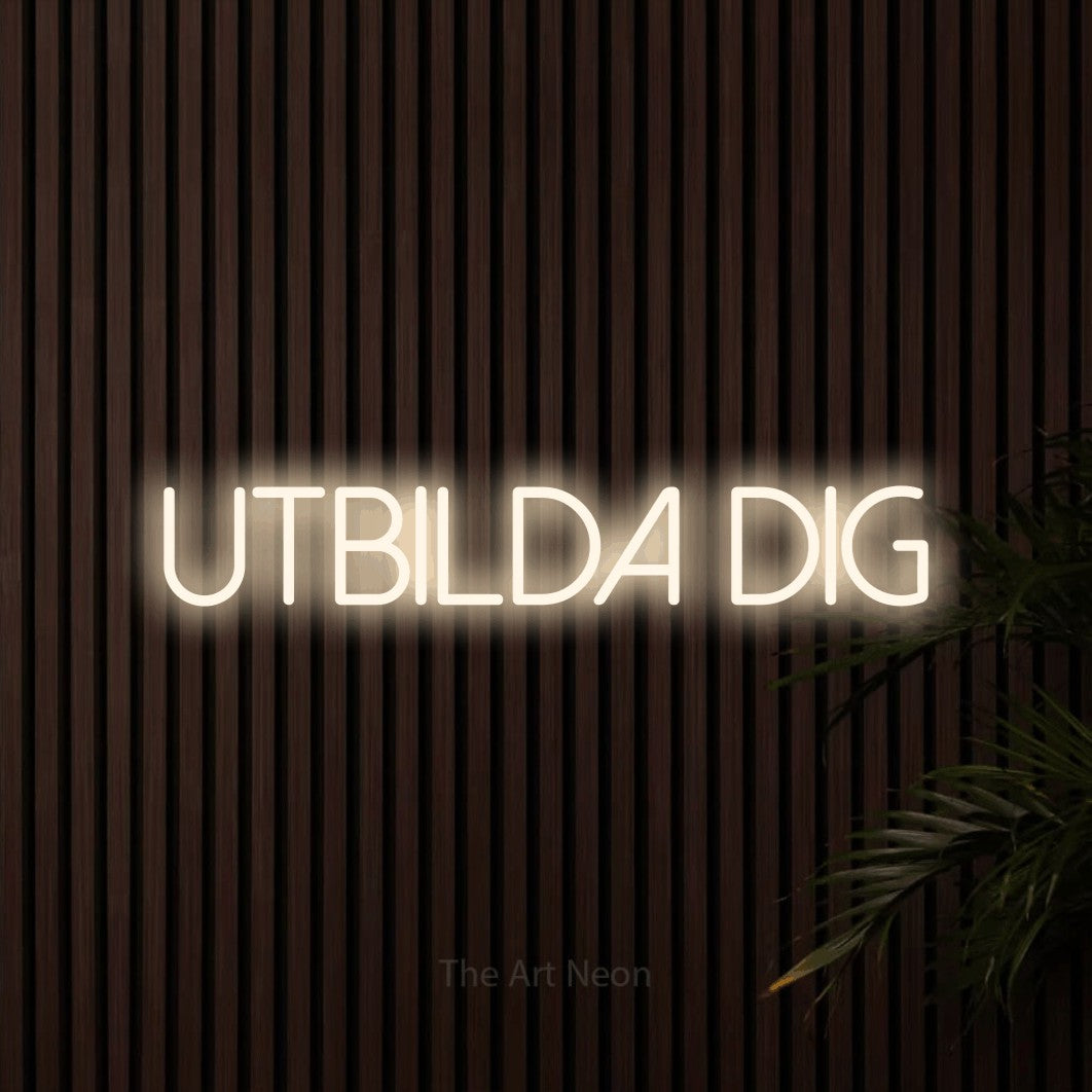 LED neon sign reading “UTBILDA DIG”, arranged in a single line.