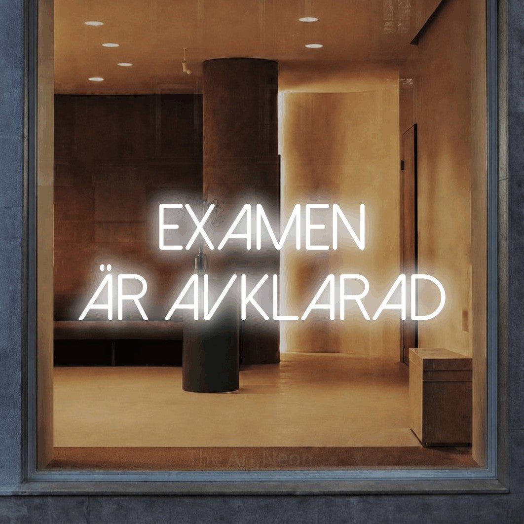 LED neon sign reading “examen är avklarad”, arranged in 2 lines.