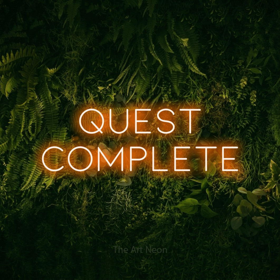 LED neon sign reading “Quest Complete”, arranged in 2 lines.