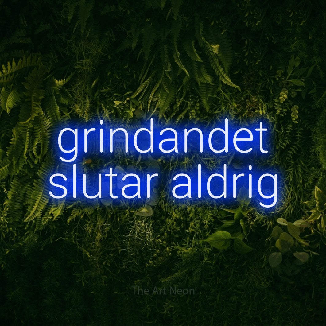 LED neon sign reading “grindandet slutar aldrig”, arranged in 2 lines.