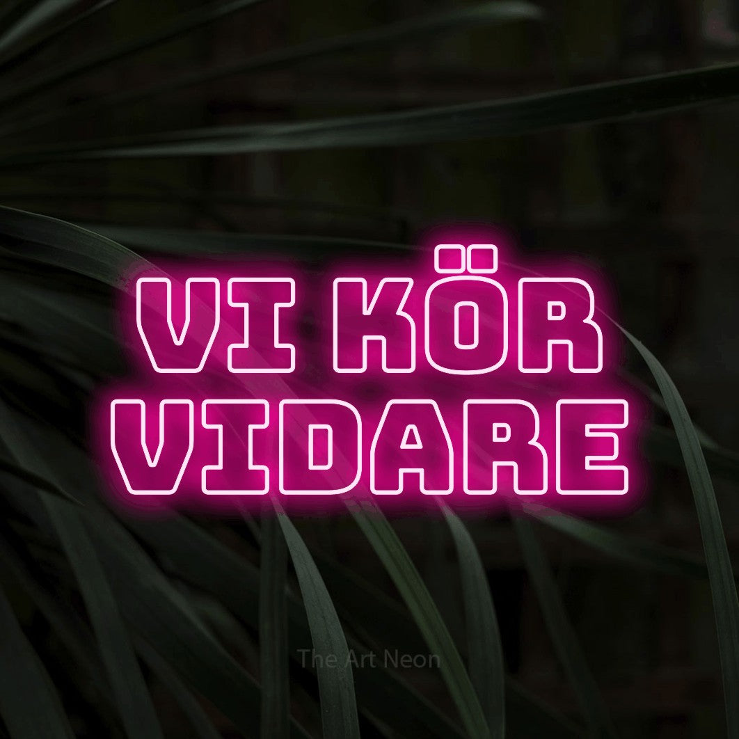 LED neon sign reading “vi kör vidare”, arranged in 2 lines.