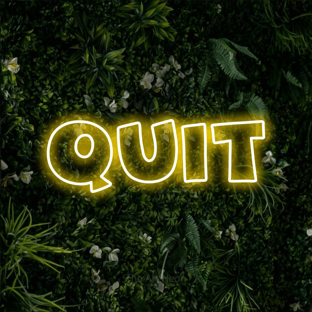 LED neon sign reading “QUIT”, arranged in a single line.