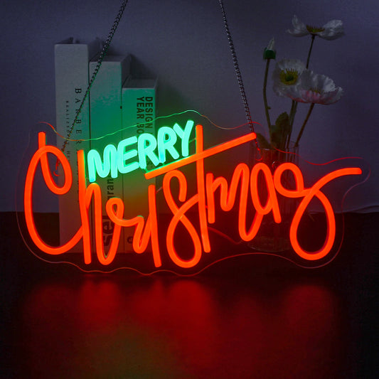 A vibrant LED neon sign displaying the festive phrase "Merry Christmas" in elegant, flowing script.