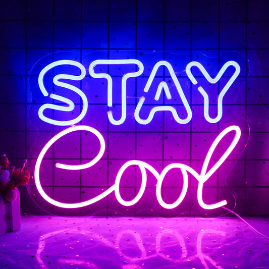 A vibrant "Stay Cool" LED neon sign is displayed, featuring bold, cursive lettering.