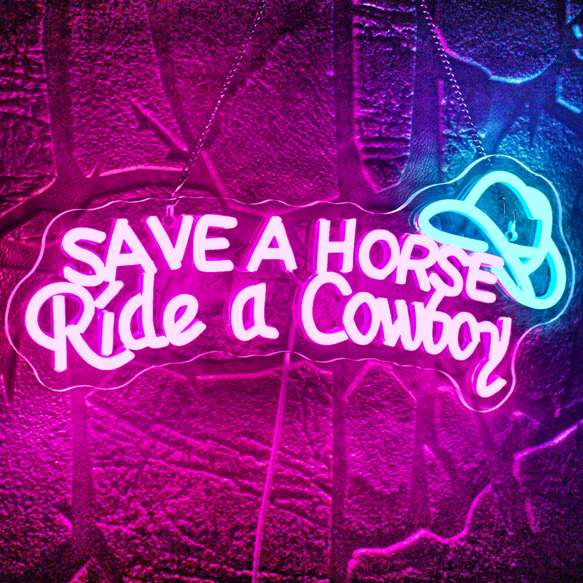 Bilden visar en levande LED-neonskylt som läser "Save A Horse Ride a Cowboy" i ett roligt, lekfullt manus.