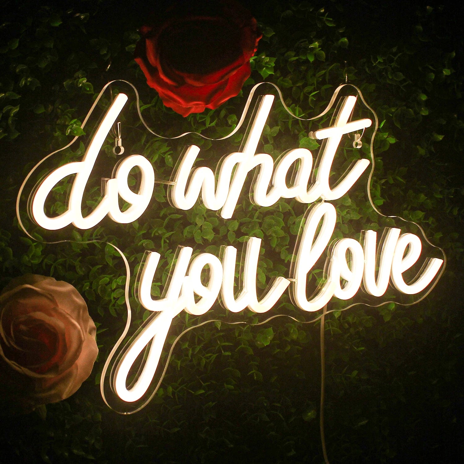 The image features a vibrant LED neon sign displaying the motivational phrase "Do What You Love" in bold, cursive lettering.