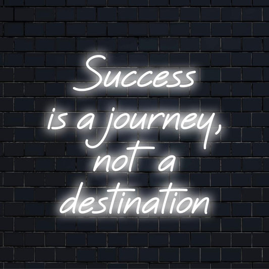 Custom LED neon sign illuminating the phrase Success Is A Journey, Not A Destination in bright artistic neon typography.